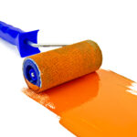 Roller paint with orange paint and a blue handle isolated on white background